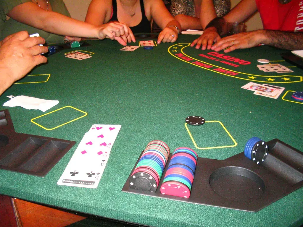 Image depicting a poker table with cards, chips, and a computer screen symbolizing online play on GGPoker.