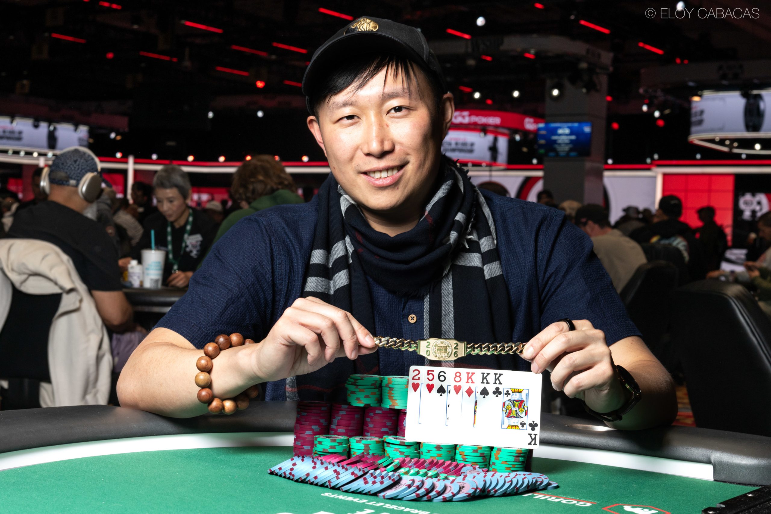 Uśmiechnięty James Cheung trzymający swoją pierwszą bransoletkę World Series of Poker